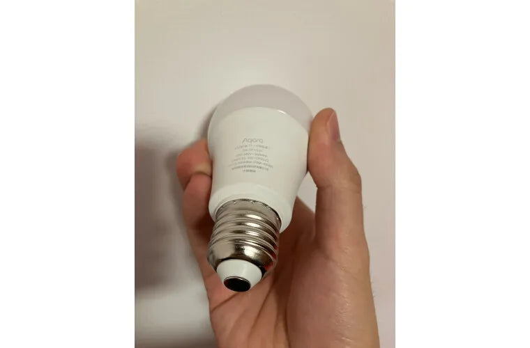 Aqara Smart LED Bulb T1 - SyncYourHome | Customer Holding a Bulb